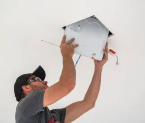 Photo of a man repairing the light at home