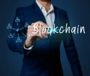 Blockchain concept business man hand writing with the word blockchain with icon