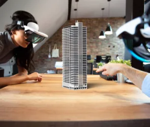Two people working on a virtual building by using AR glasses
