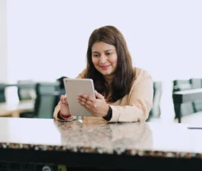 Asian Indian businesswoman working in office with Ipad