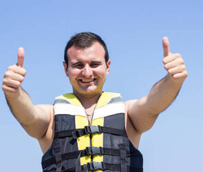 Man wearing life jacket at beach