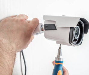 Technician worker installing video surveillance camera CCTV camera closeup